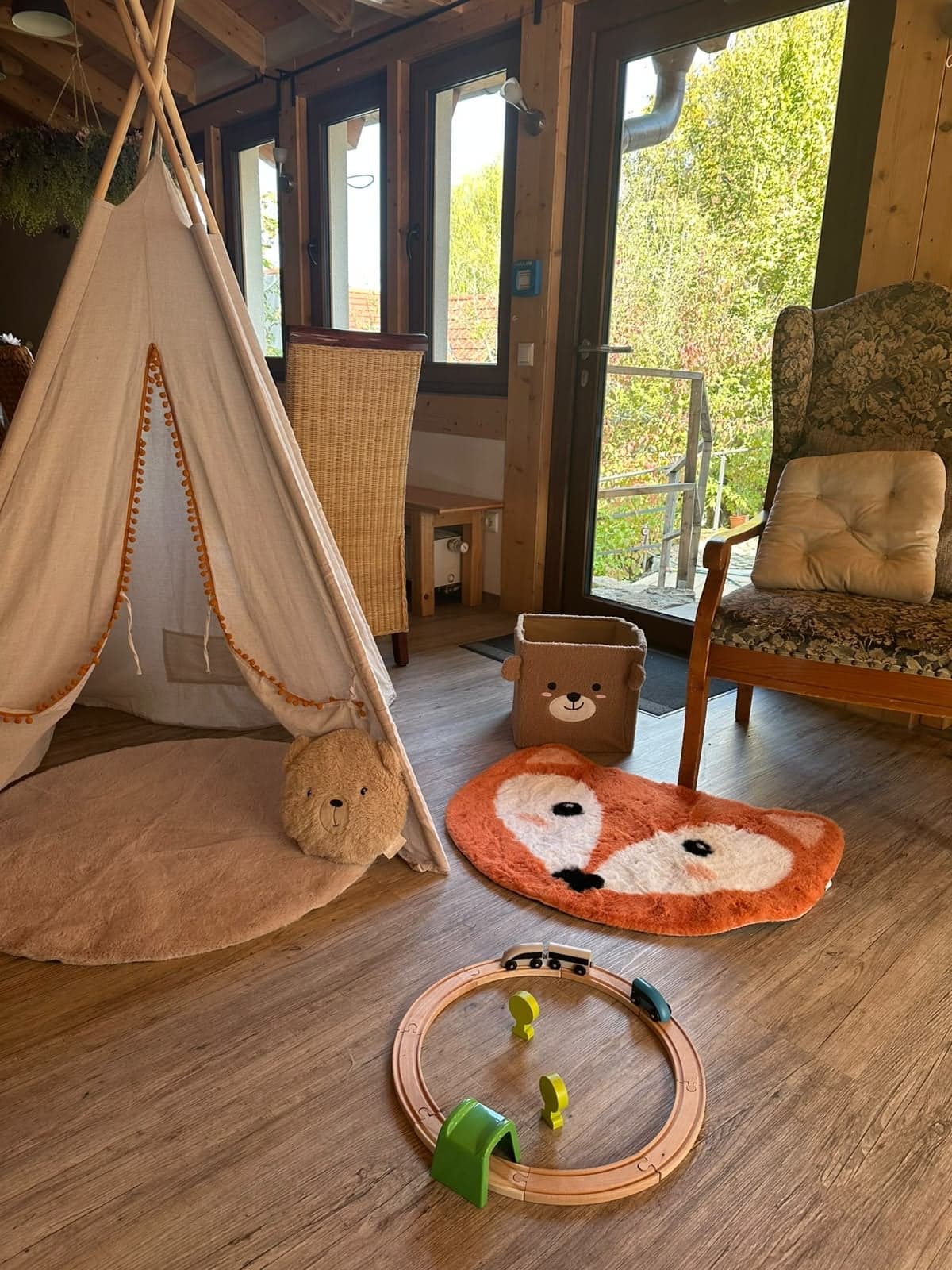 Betreuungsecke von Bambino Events mit Tipi-Zelt, Kuschelteppichen und Holzeisenbahn